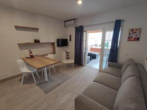 a living room with a couch and a table at Costa Adeje Fañabé Beach in Adeje