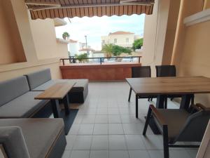 a restaurant with tables and chairs and a balcony at Costa Adeje Fañabé Beach Apartment in Adeje