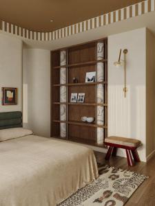 a bedroom with a bed and a chair and a shelf at Orchid Bloom Suite-City Heart-Near Street Food & Coffee 24-7 in Hanoi