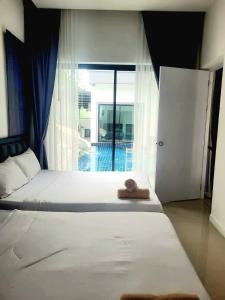 Postel nebo postele na pokoji v ubytování Villa Mellow Pattaya