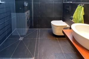 a bathroom with a toilet and a sink at Ferienwohnung Loft in Strandnähe in Norden +9 photos