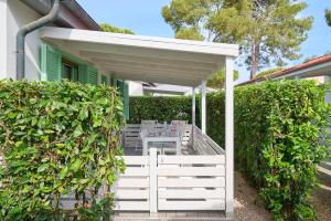 a patio with a table and chairs under a porch at Villaggio Orizzonte in Riotorto