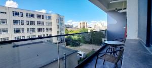 a balcony with a table and a view of a building at Relax Home apartments in Iaşi