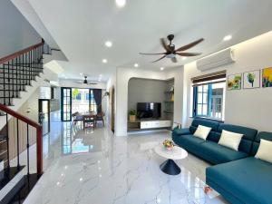 a living room with a blue couch and a table at KNK villa in Bình Tú