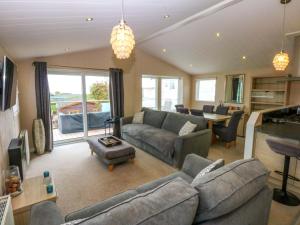 a living room with a couch and a table at The Hideaway in Afon Wen Junction