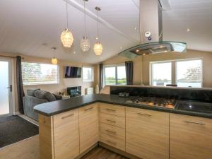 a kitchen with a stove and a counter top at The Hideaway in Afon Wen Junction