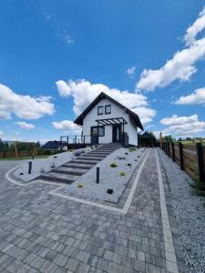 a small white house on a brick road at Sielsko i Diabelsko in Jaworzynka +9 photos