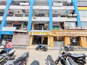 a group of motorcycles parked in front of a building at Star Hotel in Ahmedabad
