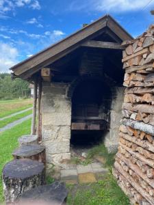 an old brick oven with a roof at Pension am Waldesrand in Regen +2 photos