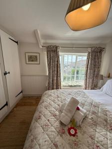 a bedroom with a bed with a flower on it at Victorian 3 Bed Cottage in Sought After Pentyrch in Pentyrch