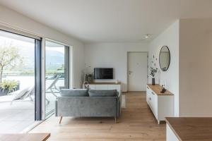 a living room with a couch and a large window at Panorama Apartment in Nalles
