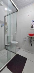 a bathroom with a glass shower and a toilet at Pousada Mar Dos Anjos in Arraial do Cabo +119 photos