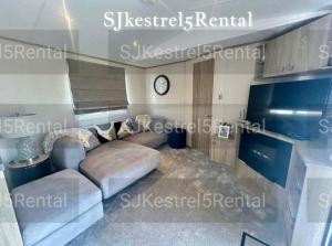 a living room with a couch and a tv at Cayton Bay Kestrel40 in Cayton