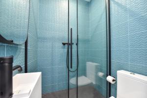 a bathroom with a glass shower with a toilet at Cosy Room - 2P - Residence - Eiffel Tower Champs de Mars in Paris