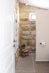 a door leading into a room with a bench at Beyt El Midan in Ehden +18 photos