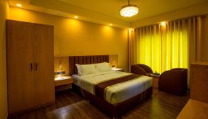 En eller flere senge i et værelse på Heritage Resort