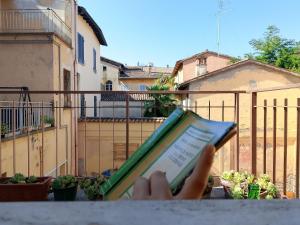 a person is holding a tablet in their hand at Arci Isola Ostello Sociale in Imola