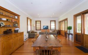 a large living room with a table and a couch at Abaleen House in Queenscliff