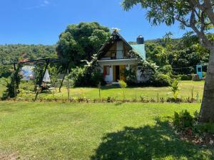 拉斯加勒拉斯Dreamvilles Ecovillage Las Galeras的一座有树和草地的房屋