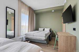 a bedroom with a bed and a mirror and a tv at Aiden by Best Western Odense in Odense +36 photos