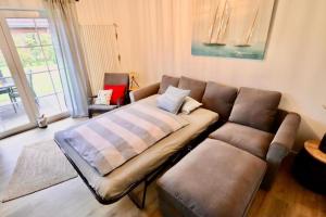 a couch sitting in a living room with at Ostfresenstuv in Neßmersiel