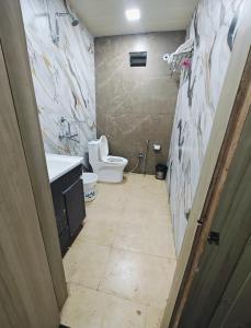 a bathroom with a toilet and a sink at Hotel Konark INN in Bareilly