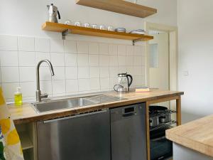a kitchen with a sink and a counter top at Old town apartment with flair centrally located in Weinheim