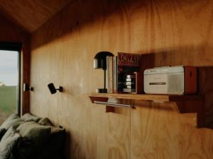 a microwave sitting on a shelf in a room at Polaris in Kelsall