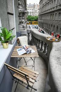 a table and chairs on a balcony on a building at Amethyst Apartments - Csepreghy in Budapest