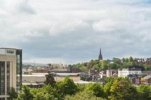 a view of a city with buildings and trees at Da Vinci's Hotel in Derry Londonderry