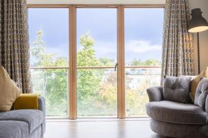 a living room with two chairs and a large window at GuestReady - Suburban retreat in Dublin in Dublin +17 photos