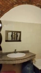 a bathroom with a sink and a picture on the wall at Nuba in Aswan