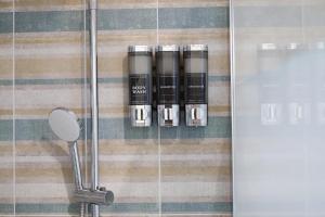 a group of bottles on a wall in a shower at Luxury B&B La casa sul mare in Taranto +16 photos