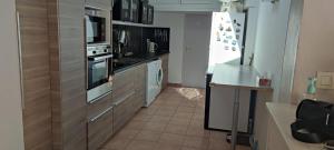 a kitchen with a stove top oven next to a counter at Sur les dunes in La Guérinière