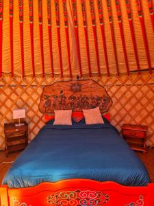a bedroom with a bed in a yurt at Yourte Mongole traditionnelle in Saint-Pé-de-Bigorre +9 photos