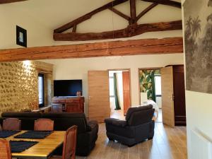 a living room with a couch and a table at La Canopée in Le Chalon