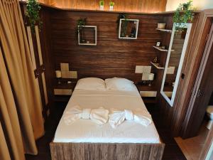 a bedroom with a bed with towels on it at Under the rocks in Kalabaka
