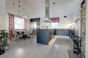 a large kitchen with a table and a dining room at VillaApaja in Rovaniemi