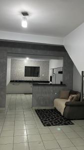 a living room with a couch and a flat screen tv at Casa da folha 12 in Marabá