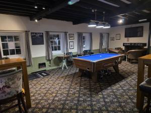 a billiard room with a pool table in it at The Bull Hotel in Downton