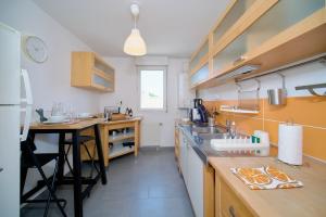 a kitchen with a sink and a counter top at Bright, 2 bedrooms, central, garage and balcony in Condrieu