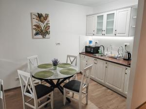 a kitchen and dining room with a table and chairs at Mountain LUX in Rudnik