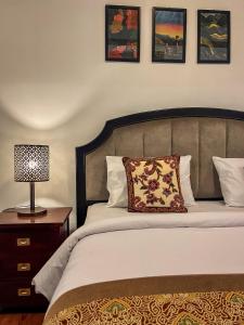 a bedroom with a bed and a lamp on a night stand at Ndalem Srigading Villa Solo in Bonorejo +36 photos