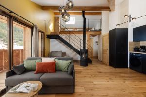 a living room with a couch and a staircase at Alpium, Morzine centre, 5 personnes in Morzine