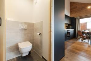 a bathroom with a toilet and a dining room at Alpium, Morzine centre, 5 personnes in Morzine