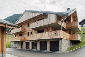 a large wooden building with balconies on it at Alpium, Morzine centre, 5 personnes in Morzine