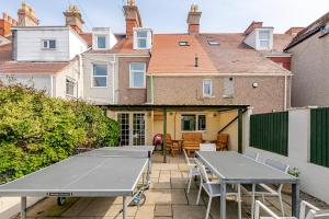eine Gruppe von Tischtennisplatten auf einer Terrasse in der Unterkunft Victorian Cartref in the heart of Llandudno in Llandudno