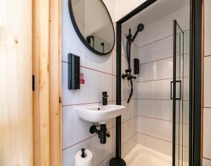 a bathroom with a sink and a mirror at easyHotel Paddington in London