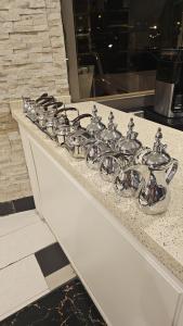 a bunch of silver faucets on a counter at ابهى لمار للشقق الفندقيه 2 in Riyadh