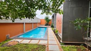 a swimming pool in the backyard of a house at Savana Stay in Puducherry